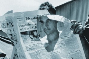 man_looking_through_hole_in_newspape_450